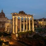 the ruins of a roman city lit up at night roman forum travel guide
